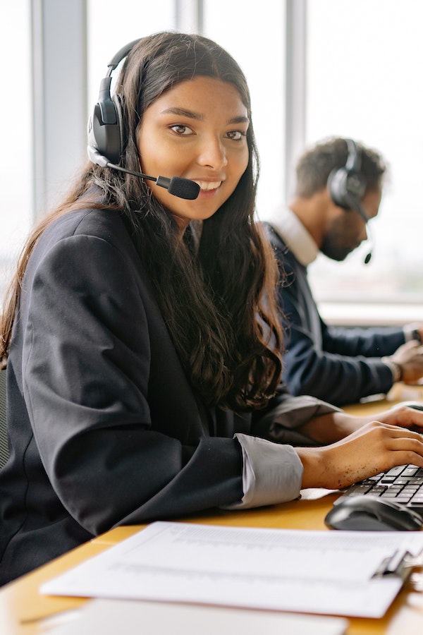Woman speaking on phone and typing